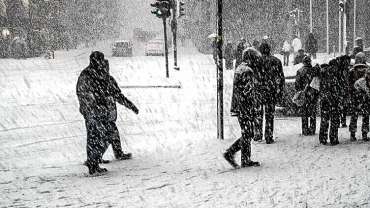 walking through snowy sidewalk without ice melting pellets