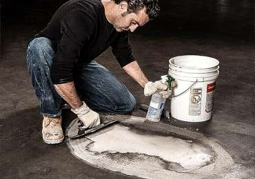 man using extreme patch on damaged floor